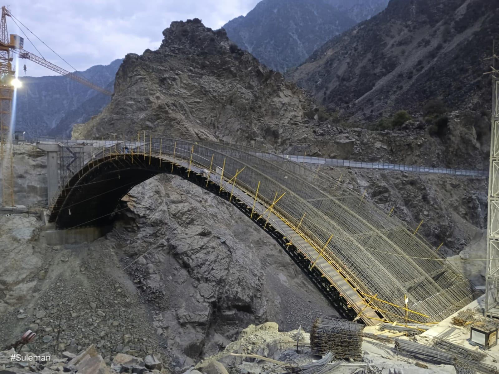 K37 Looter Bridge arch under construction at dusk, Dasu Hydropower Project
