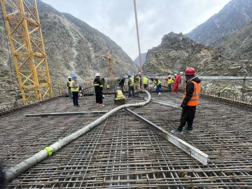 Workers placing concrete on the bridge deck
