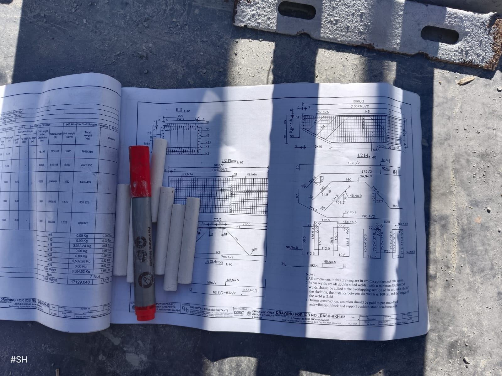 Shop drawings for the Looter Bridge pier bent cap, laid out on site with marking pens